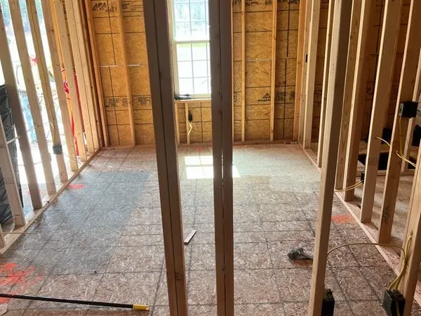 Electrical rough-in through the stud walls of a new home, wired before drywall.